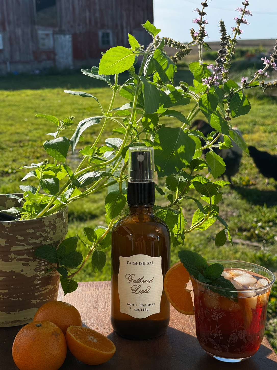 Amber fine mist spray bottle with a label that says Gathered Light
