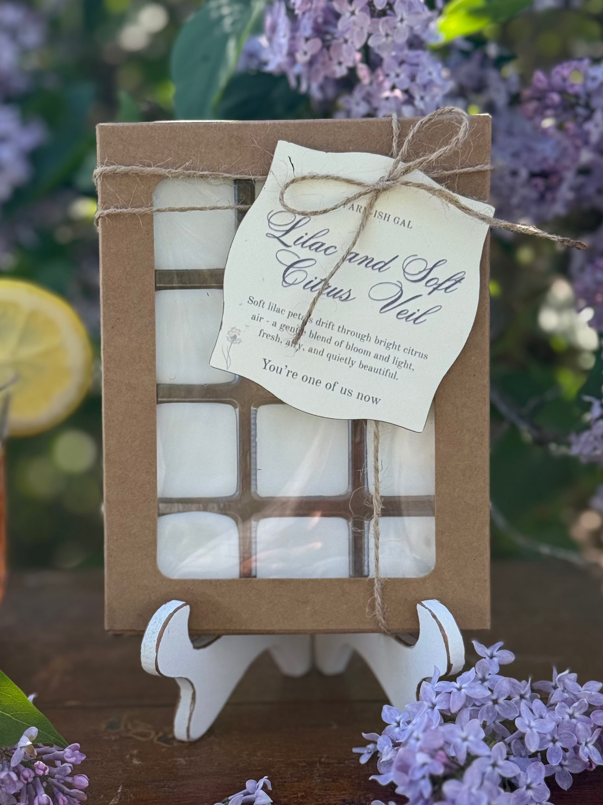 Wax melts in a Kraft paper box with a window and a tag that says Lilac and Soft Citrus Veil